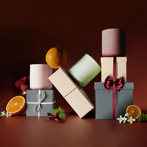 Caftari candles arranged with gift boxes for a wellness gift set