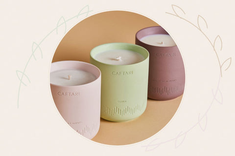 Three Caftari non-toxic candles in brand colors