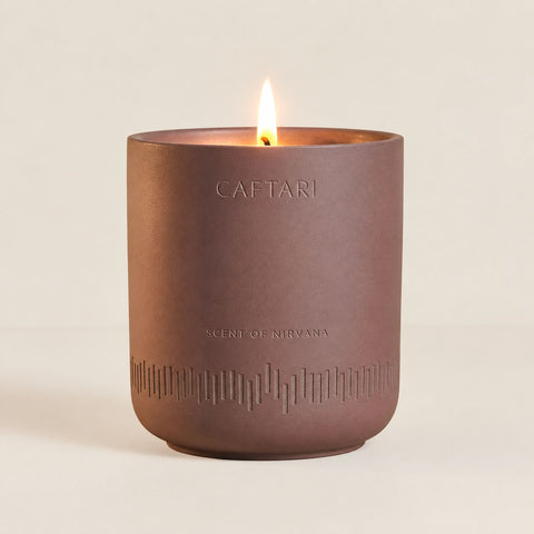 Caftari Scent of Nirvana candle with its engraved brainwave design and warm brown vessel