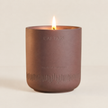 Caftari Scent of Nirvana meditation candle in a mauve ceramic vessel