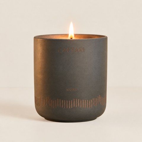 Caftari Nidra candle in a dark ceramic vessel for an evening scent ritual