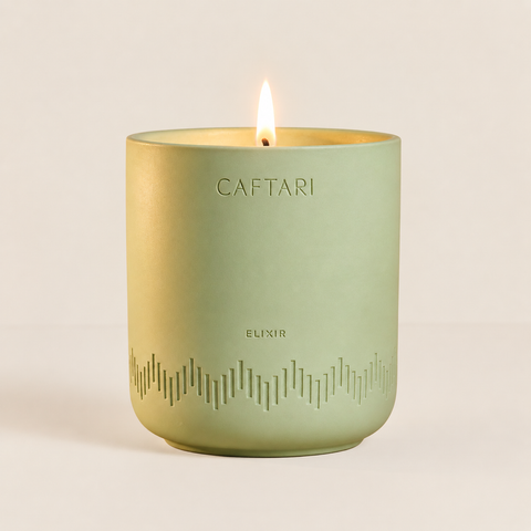 Caftari Elixir candle in a green ceramic vessel